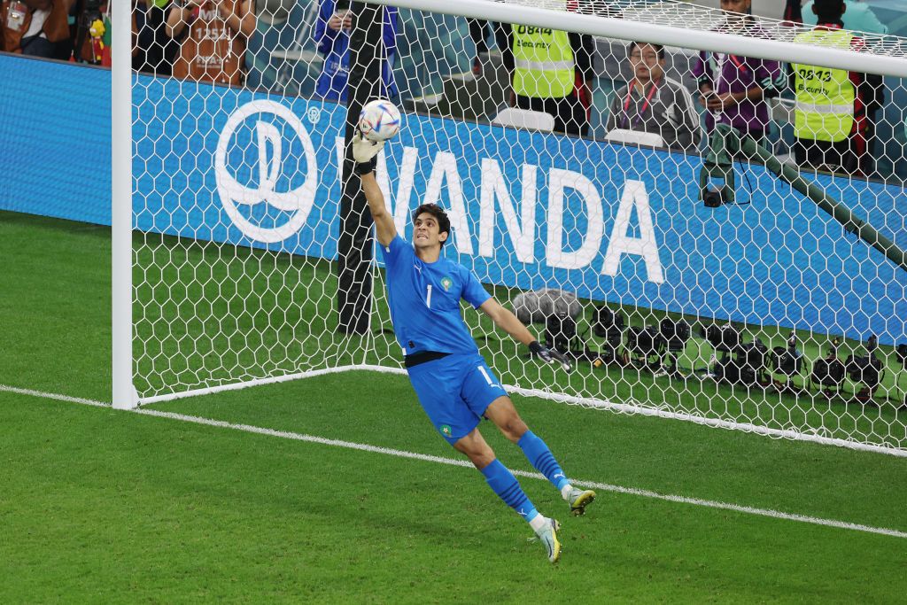 Why does Yassine Bounou have Bono on the back of his shirt? Yassine Bounou of Morocco makes a save during the FIFA World Cup Qatar 2022 quarter final match between Morocco and Portugal at Al Thumama Stadium on December 10, 2022 in Doha, Qatar.