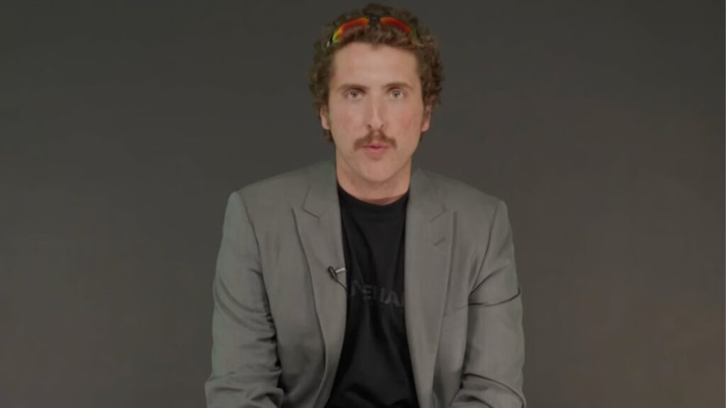 Andrew Callaghan responds as his GoFundMe raises $1.6m for Channel 5 lawsuit Andrew Callaghan in grey suit talking to camera