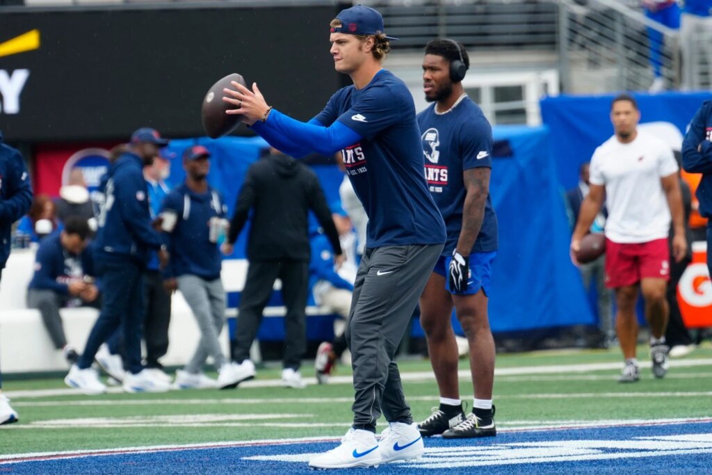 “Closest he’ll be to game action,” “he is always doing something meme worthy”: NFL fans mock JJ McCarthy for sitting alone in pouring rain before game JJ McCarthy was spotted ahead of the New York Giants game on Sunday. (Image via IMAGN Library, link attached)