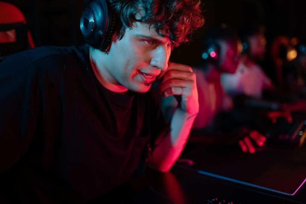 FUT’s Bucharest exit leaves cmtry likely to miss Singapore Major with Astralis Gamer wearing a headset concentrating at a PC under red light