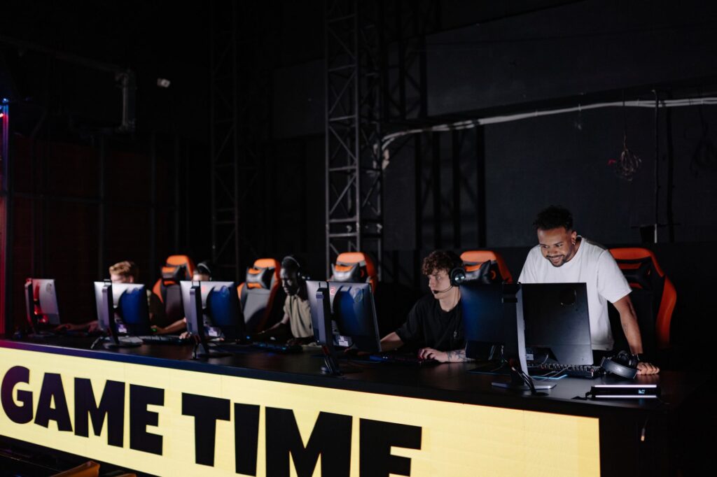 NAVI tie Team Liquid ID at 12-4 in MPL ID Season 18 and skip the playoff first round Esports players at computers on a dark tournament stage behind a GAME TIME banner